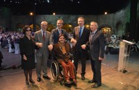 Responsables de la ONCE sobre el escenario del acto institucional en Sevilla