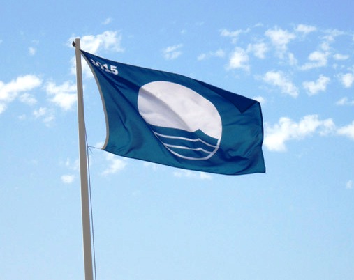 Una bandera azul ondeando en una playa española
