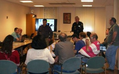 Miembros de la Policía Nacional intervienen ante el auditorio reunido en la sede de la ONCE en Córdoba