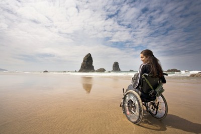 Una joven en silla de ruedas en una zona de playa