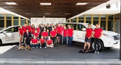 Los representantes institucionales posan, tras la firma, con los atletas convocados y varios de los vehículos donados por Toyota