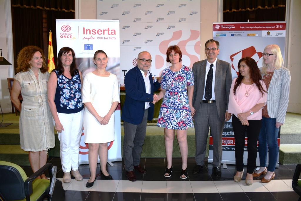 Virginia Carcedo y Francesc Roca (en el centro) aprietan sus manos rodeados por sus equipos de colaboradores, tras firmar el convenio