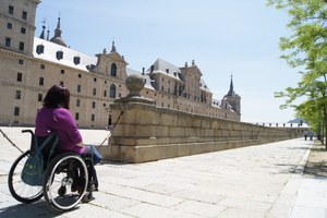 Mujer en silla de ruedas visitando el Monasterio de El Escorial, en Madrid