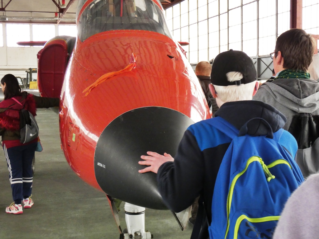 Uno de los jóvenes ciegos toca el morro del avión C101