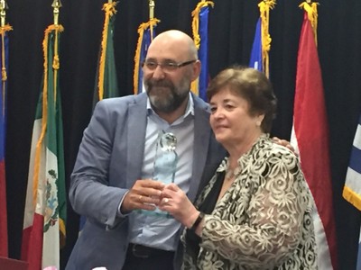 Eugenio Romero recoge el premio, en nombre de Pilar Gómez, de manos de la vicepresidenta de Deafblind International, Bernadette Kappen 