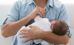 Imagen de un padre con su bebé en brazos
