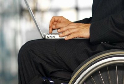 Primer plano de un hombre en silla de ruedas utilizando un ordenador portátil