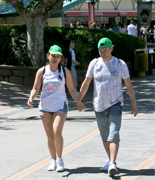 Una pareja de jóvenes, tocados con la gorra de la ONCE, a la salida del Parque