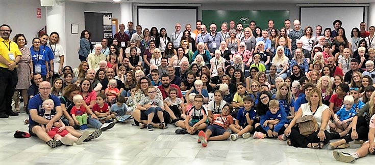 Foto de familia de los participantes junto a familiares y profesionales