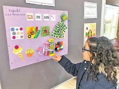 Una niña observa los trabajos expuestos al final de la Semana