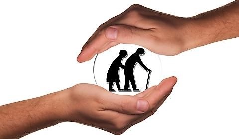 Pictogramas que refleja unas manos protegiendo a la imagen de una pareja de ancianos