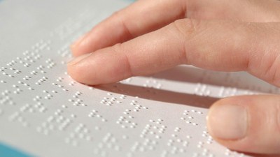 Mano leyendo braille