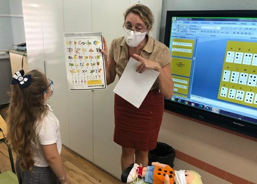 Remedios Rodríguez muestra a una alumna el alfabeto braille