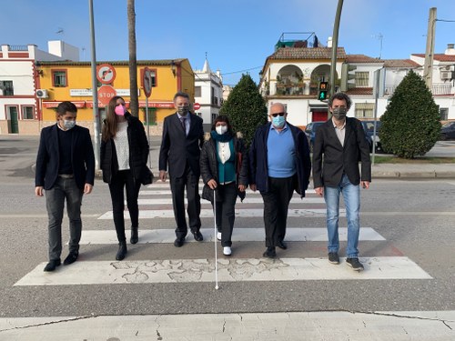 Afiliados y responsable de la ONCE junto al edil de La Rinconada, realizando el cruce un paso señalizado por uno de estos semáforos