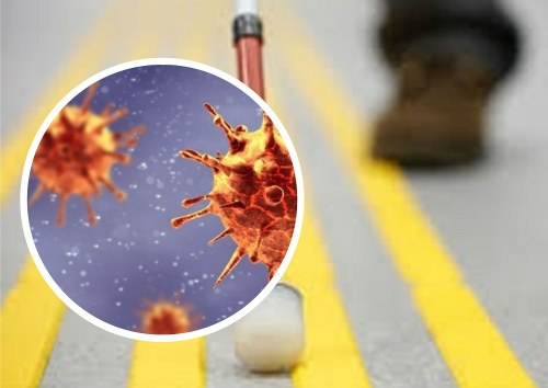 Imagen del coronavirus sobre el fondo de un bastón blanco de personas ciegas