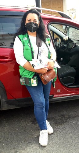 Foto de la vendedora junto al vehículo que utiliza para realizar su trabajo.