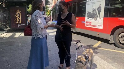 Natalia Chueca y Silvia Borrego charlan junto a uno de los autobuses dotados del sistema Navilens en el acto de presentación