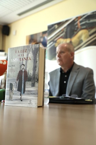Portada del libro en primer plano con el autor, Alan Hald, detrás