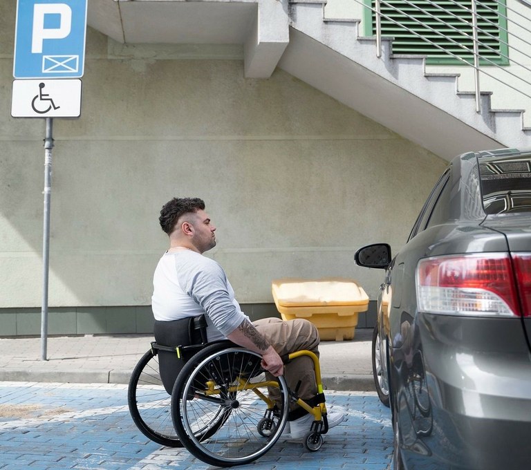 Hombre con discapacidad accede a su vehículo estacionado en una zona reservada para personas con discapacidad