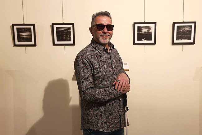 JM Magano delante de algunas de sus fotografías
