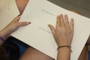 Una alumna consulta una ficha de trabajo en braille